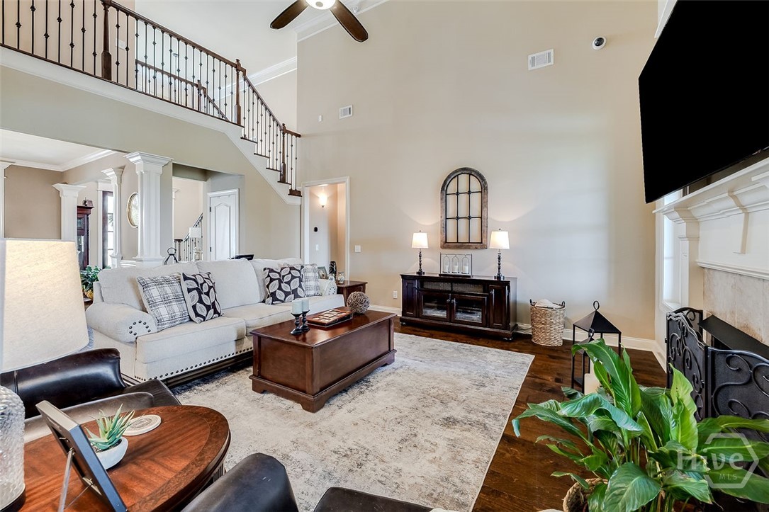 spacious living room with fireplace, cathedral ceiling and cat walk to upstairs bedrooms