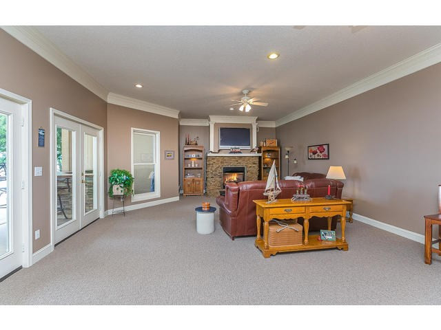 Family room on lower level with fire place and lak