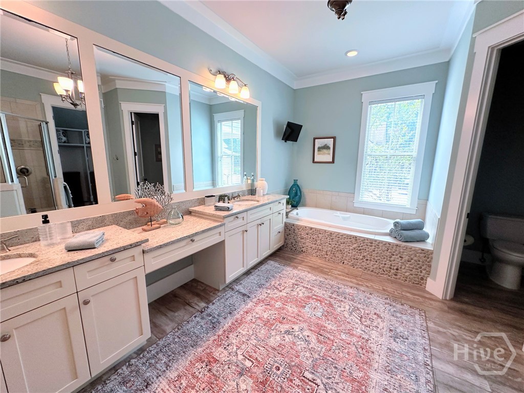 Spacious primary bathroom with two sinks.