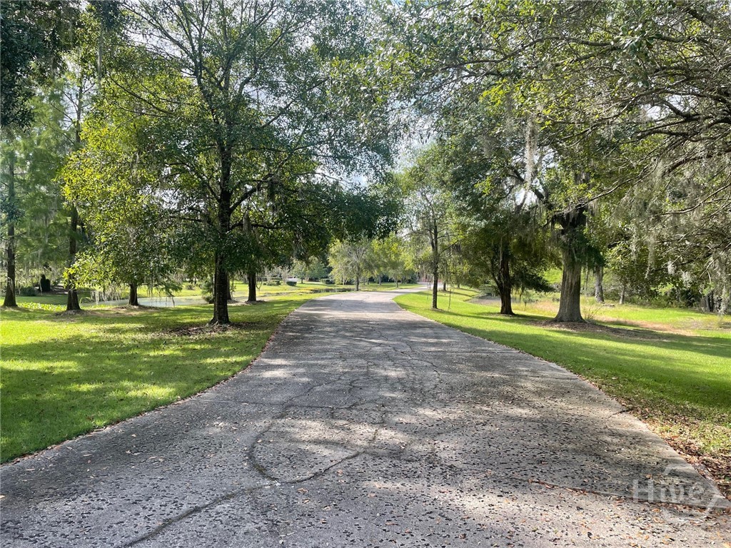 Nestled among the trees the long entry offers priv