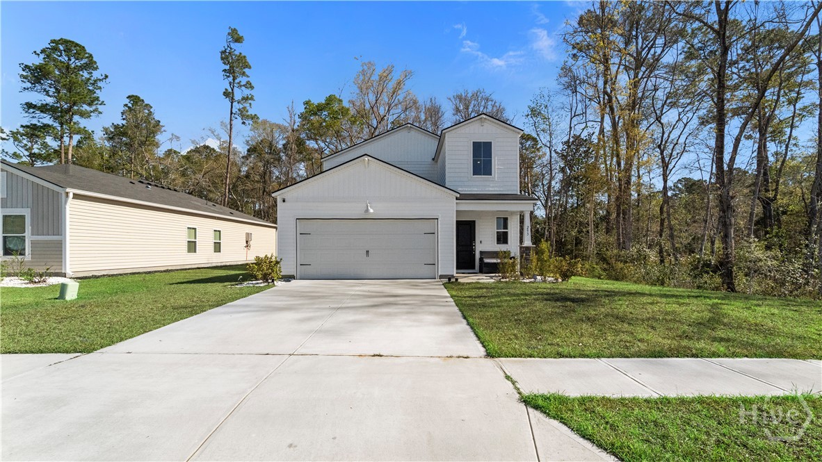 If you’re looking for space and modern finishes with an easy commute to Savannah, Georgia, 293 Lillian St. in Rincon’s Raindance neighborhood delivers a layout that works for real life: Flexible living areas. Primary on the main floor.  A design that keeps everything connected. This home balances daily routines with room to grow.A wide entry hall leads past the staircase and a conveniently located powder room before opening into the main living space, flowing through the dining area and kitchen to the living space. The bright and stylish kitchen features white cabinetry, granite countertops, gunmetal stainless appliances, a gas range, custom tile backsplash, and an additional walk-in pantry. Just off the kitchen, the laundry room provides easy access to the two-car garage, adding practical function where it matters most.The main-floor primary bedroom offers large windows and space for a full furniture setup. The primary bath includes an expansive dual vanity with ample storage, a step-in shower, and a large walk-in closet.Upstairs, a lofted bonus area creates a second living space, playroom, or study zone. Four additional bedrooms feature generous closets and share an oversized bath designed for efficiency, with dual vanities in one area and the tub/shower in a separate space. Extra hall storage adds even more functionality.Outside, a sliding door from the living area leads to a deck with railing overlooking treed land behind the home, offering a more private outdoor setting for relaxing or entertaining.Located in Effingham County, you can walk to Ebenezer Elementary, making school mornings easier, and less than 10 minutes to shopping and dining in Rincon. Raindance offers a convenient location with access to I-95 or I-16, making the commute to downtown Savannah, Gulfstream, Hunter AAF, the Hyundai Metaplant, or the Port of Savannah manageable while offering green space and community.