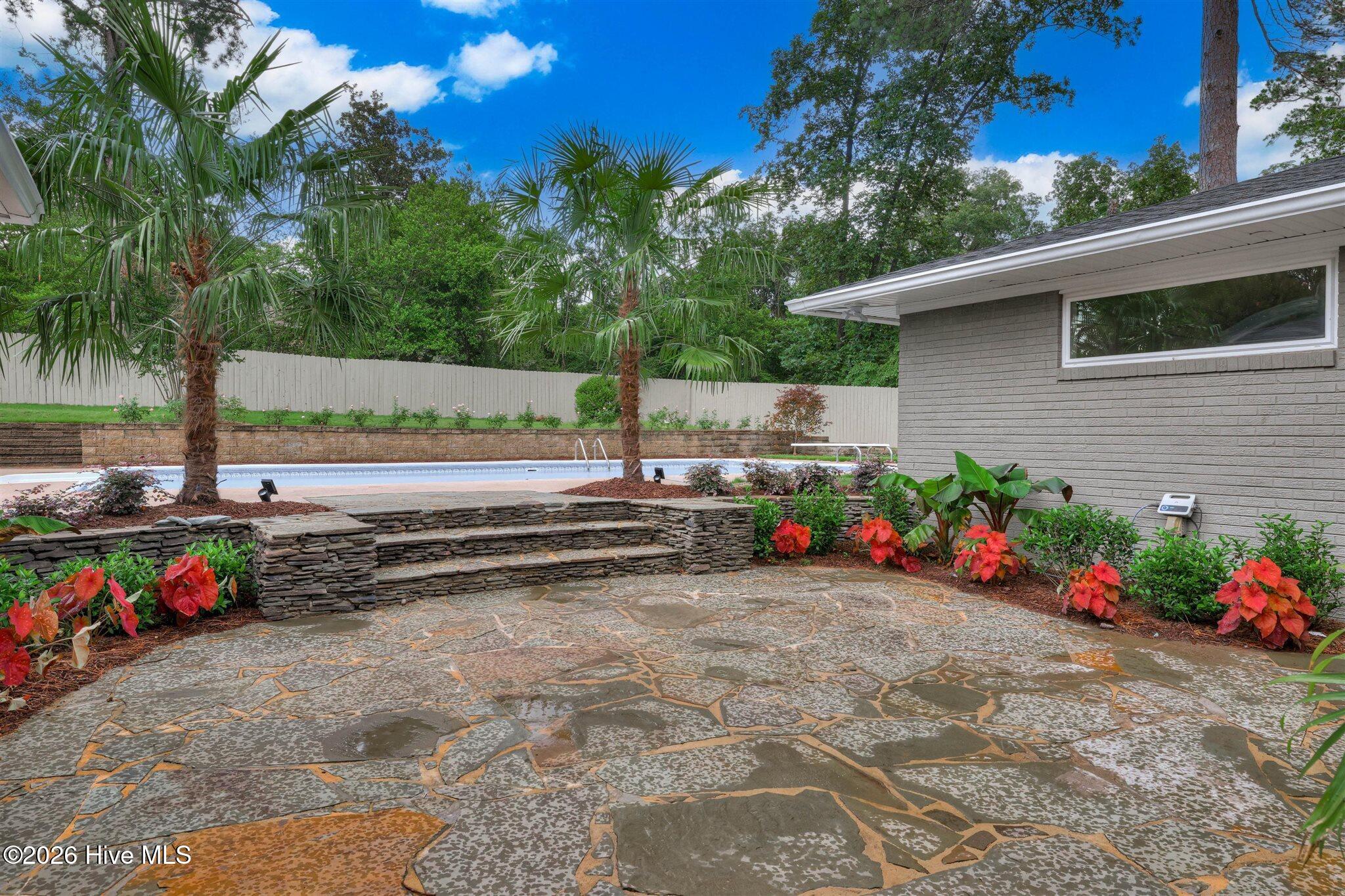 Feature - Private, landscaped patio with views of the pool.