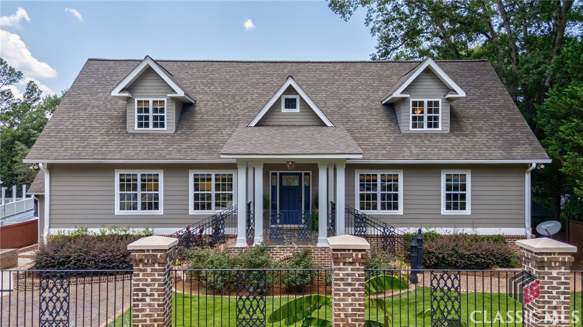Welcome to 224 Fortson Drive!  Perched on the edge of Five Points, this stately, four-level home spans over 8,300 square feet and has been thoughtfully renovated by the current owners to enhance flow, function, and style, blending timeless architecture with fresh, modern appeal.
Recent updates include:
removal of select walls to create a more open, airy layout, new designer light fixtures, interior repainted in a soft, neutral palette, refinished hardwood floors and select countertops updated with high-end materials.  These updates, combined with meticulous maintenance, make the home feel like new—while preserving its classic character.
Beyond the lush landscaping of the front yard, the welcoming covered front porch opens to a grand entry hall flanked by elegant living spaces, each enhanced by detailed millwork and large, light-filled windows.
The heart of the home is an entertainer’s dream: a chef’s kitchen featuring professional-grade appliances, custom cabinetry, stone countertops, and a large island, plus a scullery kitchen for prep and cleanup. On the other side of the home is a wet bar, located just off the office/den, which provides the perfect spot for cocktail hour.
The owner’s suite is privately located on the main level and features a dramatic two-story ceiling, fireplace, and large windows. The luxurious en suite bath includes a double granite vanity, jetted soaking tub, custom steam shower, and cedar walk-in closets.

Upstairs is a cozy loft area that could be used as an office or reading nook as well as  two oversized bedrooms with en suite baths.

The terrace level offers incredible flexibility for hosting guests or multigenerational living, with three additional bedrooms (each with en suite baths), a spacious family room with fireplace and custom millwork, a second full kitchen, and access to the backyard through French doors. A sunroom with exterior entry and an additional laundry room complete this level.

On the lowest floor, a flex space that was used as a home gym/yoga studio includes a full bath and second steam shower—perfect for wellness routines or guest overflow.

Outside, the resort-style backyard is built for entertaining: a multi-level flagstone patio with covered outdoor kitchen and grilling station, double-sided wood-burning fireplace, and lounge area flows to a heated saltwater pool and spa, a putting green, and a chipping area, all surrounded by mature landscaping and high fencing for privacy.

Located just minutes from Five Points, Beechwood Shopping Center, local hospitals, downtown Athens, and The University of Georgia, this home offers luxury, flexibility, and modern comfort in an unbeatable location.
