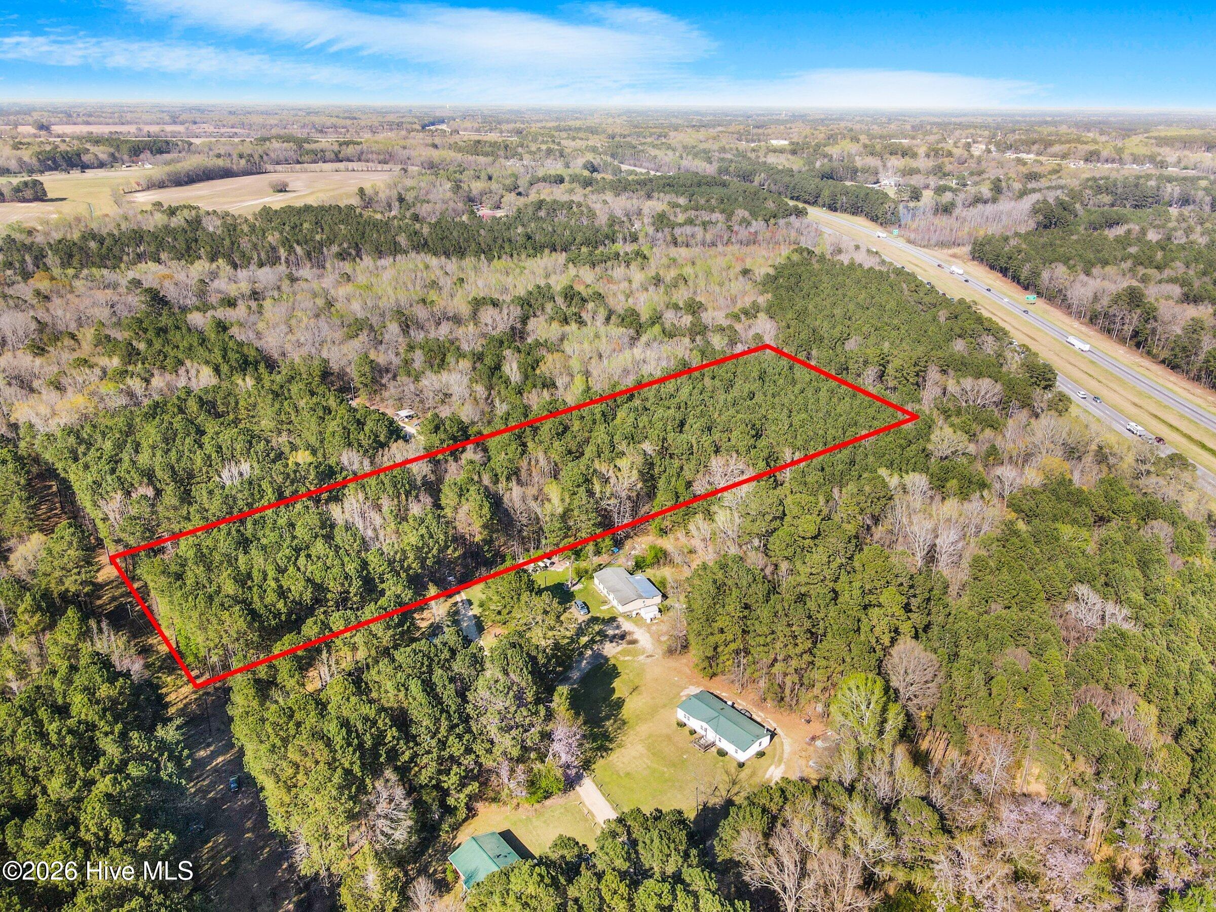Aerial Outline of 3.6 Acres, Cedar Creek. An aerial view with the approximate outline of the 3.6 acre lot, a long wooded rectangle in the Cedar Creek area near Fayetteville.