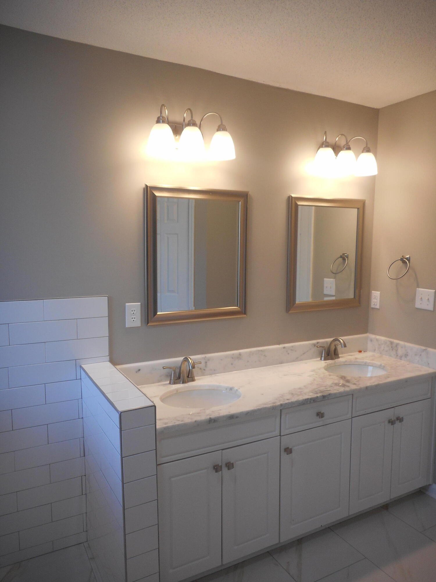 Double vanities, granite countertops and framed mirrors