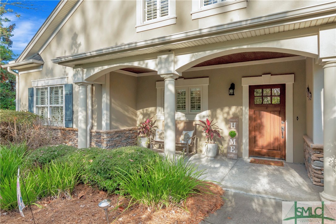 This Carriage Home, and former model townhome, and is brimming with upgrades and high-end features! At its heart is a great room with hand-scraped wood floors, cathedral ceilings, and a wood-burning fireplace. The great room and formal dining room open to a screened lanai with tranquil wooded views. The kitchen features custom cabinetry and luxury line appliances. A unique feature is the private retreat accessible through a bedroom closet, ideal for an office or studio. Further highlights include crown molding, custom closets, wet bar w/ wine cooler, and plantation shutters. Carriage Home Regime Fee Includes - structures and exterior replacement insurance, exterior maintenance (painting, etc.), landscaping, power washing, gutter cleaning, roof maintenance, irrigation, and exterior pest control. Schedule a showing to discover additional upgrades and features.