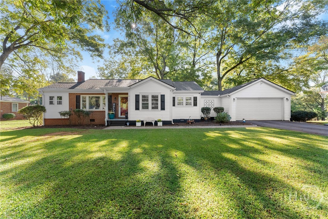 Welcome home to this beautifully maintained mid-century ranch where timeless character meets modern comfort. Nestled on a level, shaded city lot, this home offers easy everyday living with light filled rooms, original hardwood floors, and freshly painted interiors. The living room’s wall of windows brings in natural light and frames peaceful views, while a cozy fireplace adds warmth. The layout flows into a cheerful dining area and updated kitchen with new cabinetry, ample counter space, and bar seating for casual meals. An enclosed porch, currently a playroom, offers flexible use as a sunroom, office, or creative nook. The primary suite addition provides a private retreat with dual walk-in closets and an ensuite bath. Two additional bedrooms are bright and spacious. Out back, enjoy a deck overlooking the fenced yard, great for play, pets, or outdoor gatherings. Convenient to downtown Commerce and Commerce City Schools, with an optional adjoining .42-acre lot for added potential.