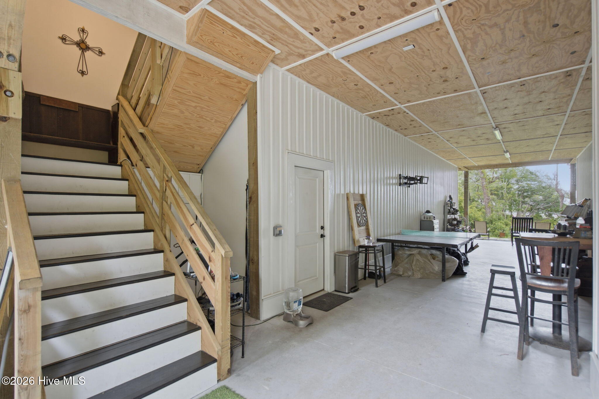 Drop zone/ inner stairwell . Heated and cooled storage/gym and shop to left and right
