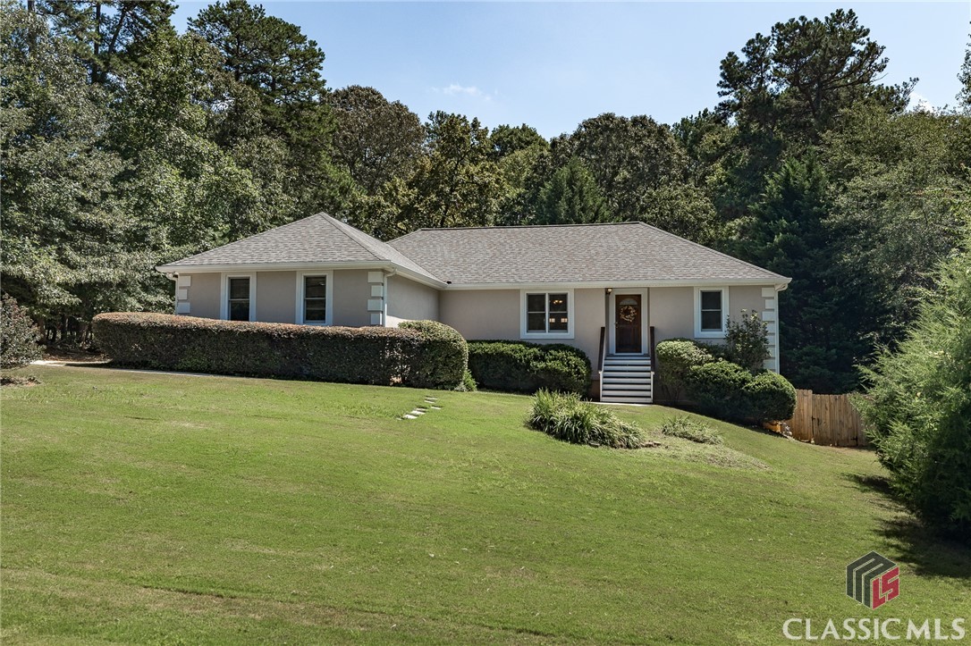 Welcome to 127 Montclair Court located west of Athens in Bogart! This 3 bedroom, 3 bathroom property has been well maintained, updated, and is move-in ready. On the main level, you'll find 3 spacious bedrooms, each with plenty of closet space and natural light. The secondary bedrooms are split from the primary bedroom ensuite. On this level, you will love the updated kitchen, formal dining space, and large living area that opens to a nice deck overlooking the quiet and private fenced-in backyard.Downstairs is a finished basement, complete with a kitchenette, full bathroom, flex room, living room, and plenty of natural light. The perfect space for hosting guests or creating a cozy retreat for yourself.Features include hardwood floors, fresh paint, a new roof and garage door in 2020, and a new HVAC in 2018.