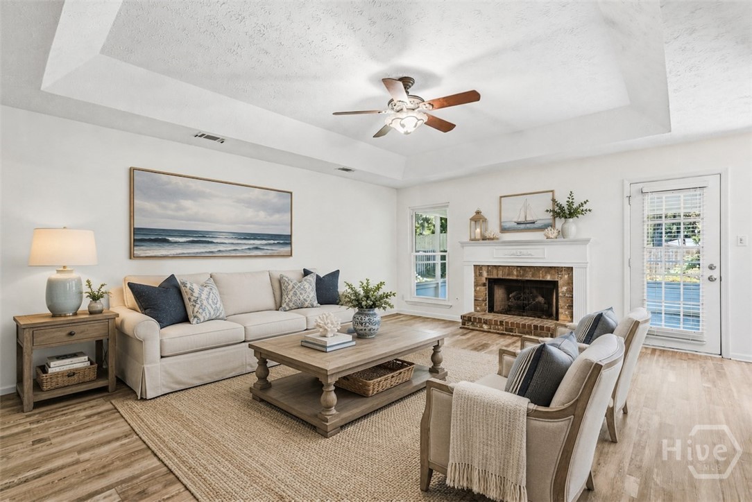 The living room has been virtually staged to show you how it would look with furniture and decor.