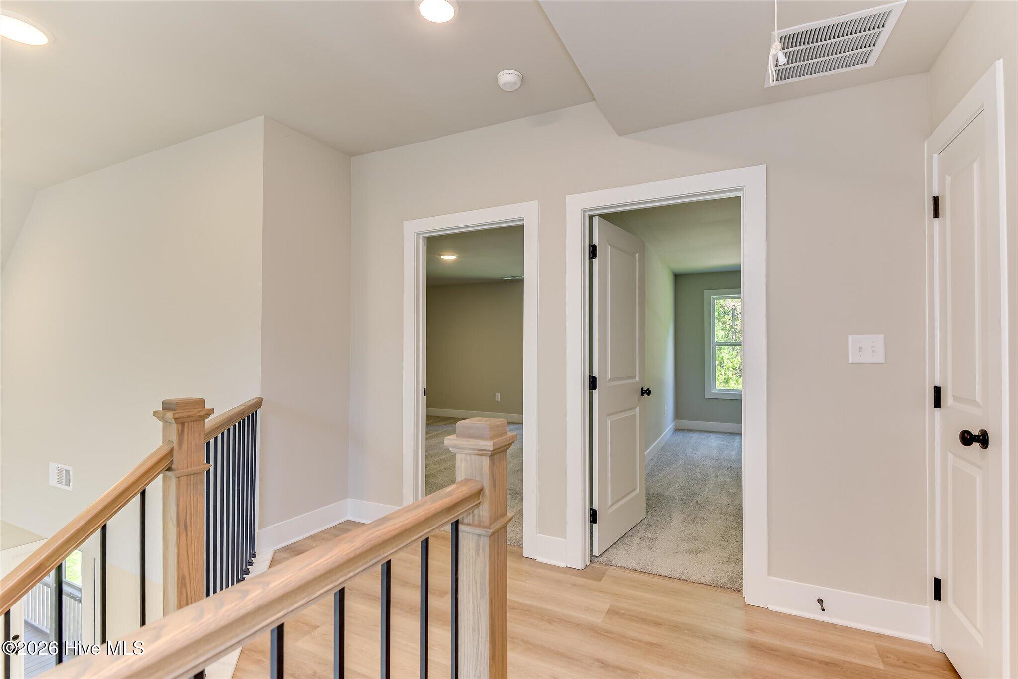 Two bedrooms, a full bathroom, and a utility room are upstairs.