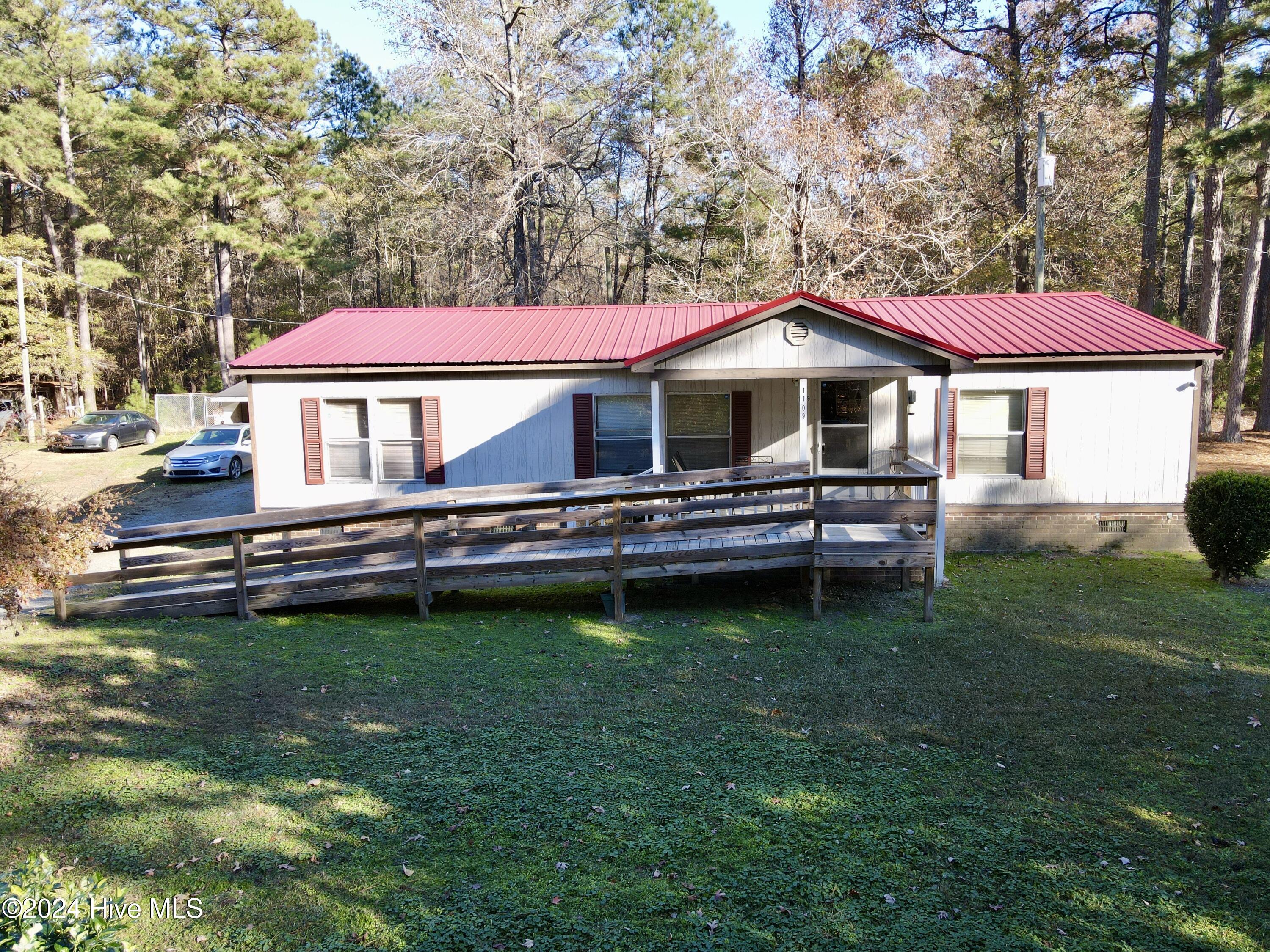 Embrace the beauty of country living with this charming 3-bedroom, 2-bathroom double-wide mobile home, built in 1999 and set on a picturesque 0.43-acre cleared lot. Surrounded by the sights and sounds of nature—chirping birds and freely roaming deer—this peaceful retreat is ready to welcome its new owners. 
Step inside to discover a thoughtfully designed interior featuring an open kitchen equipped with modern appliances, including a refrigerator and electric stove/oven—perfect for all your culinary endeavors. The kitchen flows seamlessly into a bright dining area and a spacious living room, making it an inviting space for entertaining family and friends. 
Unwind in the luxurious master suite, boasting a large garden tub, double vanities, and a generous walk-in closet. Two additional bedrooms also offer ample space and walk-in closets, providing comfort and convenience for the whole family.
Outside, the property features a newly replaced metal roof and a detached double carport with additional storage space. The home is connected to a shared community septic and well water systems. 
Located in the heart of eastern North Carolina, this property offers a serene lifestyle with endless potential. With just a little TLC, it could become your hidden gem. Don't miss this opportunity to experience the tranquil charm of rural living. Call today to schedule your tour and make this slice of the countryside your own!