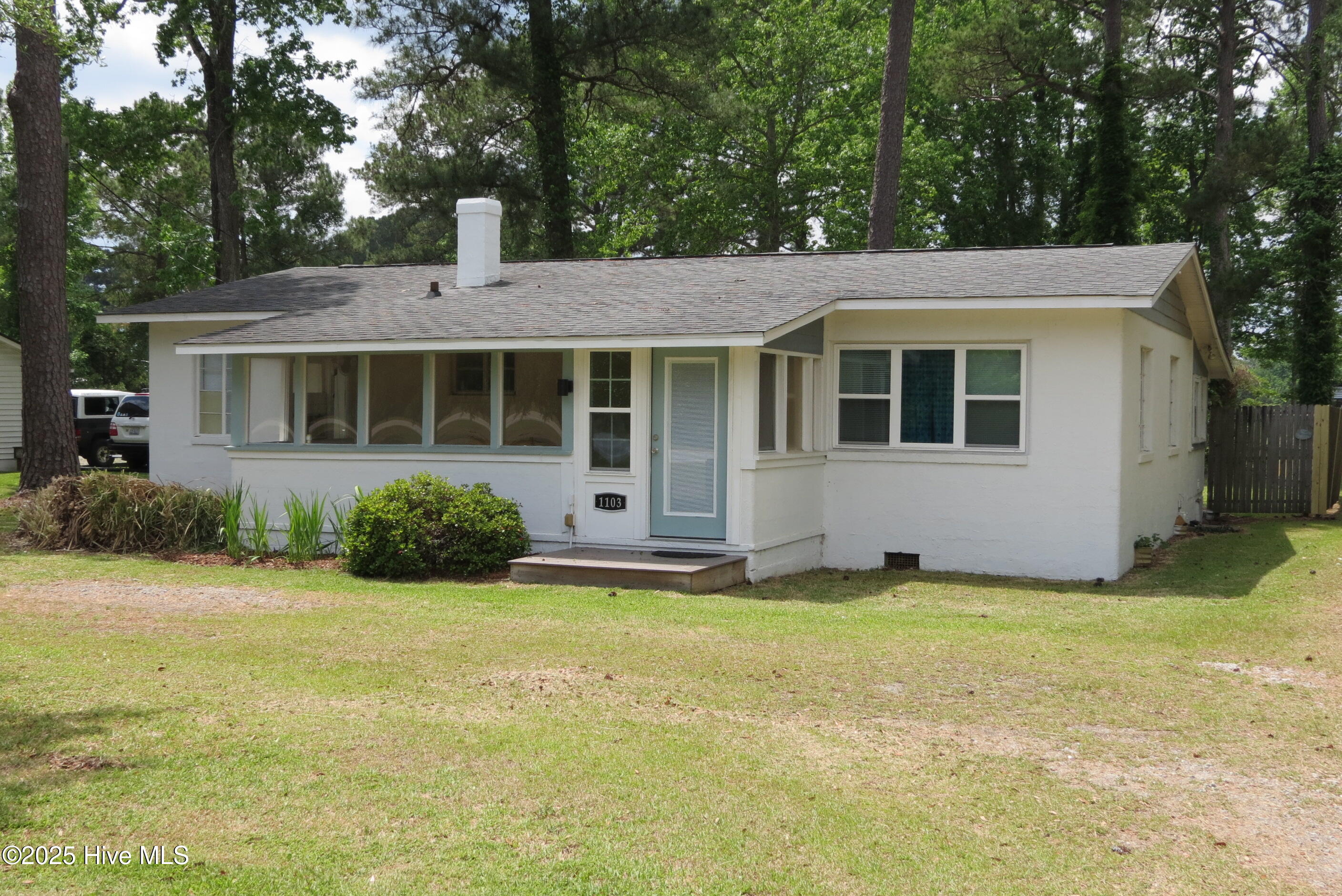 1103 Broad Street Ext Oriental, North Carolina A RESIDENTIAL/COMMERCIAL OPPORTUNITY ON BROAD STREET - ORIENTAL!!
Located in the heart of Oriental's business community on Broad Street (Rt. 55), you'll be impressed with this .41 acre offering's many possiblities. Have you ever wanted to operate an AirBnB or home business? You can let your dreams be your guide, and you'll enjoy the benefits of town without the burden of Oriental's zoning ordinance, as this property adjoins the town, but isn't within the Village's corporate limits!!!
The residence is perfect as a cozy three-bedroom home and would make an ideal rental investment or getaway. The block structure harkens back to the solid mid-century character of town and is approached via a circular drive with a nice live oak tree gracing the streetside. The front porch is enclosed with a wood ceiling and wainscotting. This creates a nice transition as you step up into the home and the Living Room. It has wood floors & flows into the bedrooms' hallway and the large Country Kitchen! It has been updated and features recent cabinetry, counters and appliances! There's lots of room for an island or additional furniture, too... Adjoining it is the rear-facing dining/multipurpose room, with access to the unique wooden patio & quiet backyard. The bedrooms are comfortable and well-proportioned, all sharing a tiled hallway bath. The master bedroom faces the backyard which has some nice mature trees offering shade and privacy. As a commercial option, you couldn't pick a more choice & prominent location for access and visual impressions from locals and visitors alike! Considering an office? A small retail space or coffee shop? Look no further! The property is unrestricted by deed, the home is expandable and ready for your plans! Gas pack central HVAC, sewer service and NOT IN THE FLOOD ZONE! Take a look soon - You'll love the vernacular charm and the obvious investment potential of this unique property! Includes a great 24' x 24' Storage Building for all your tools and toys