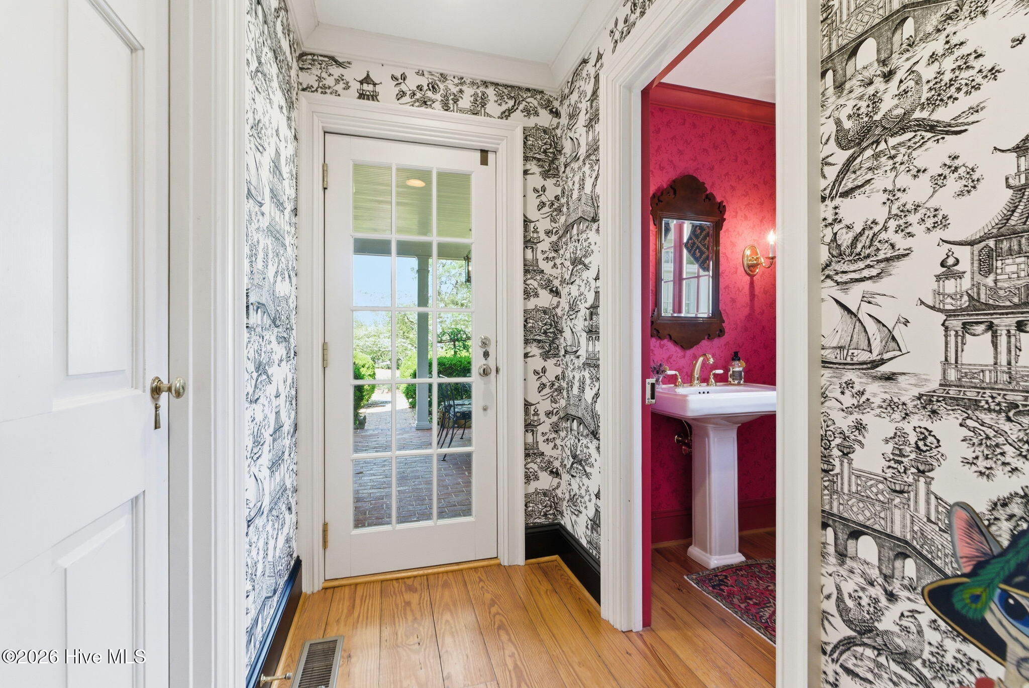 Access door off kitchen to side porch and powder room