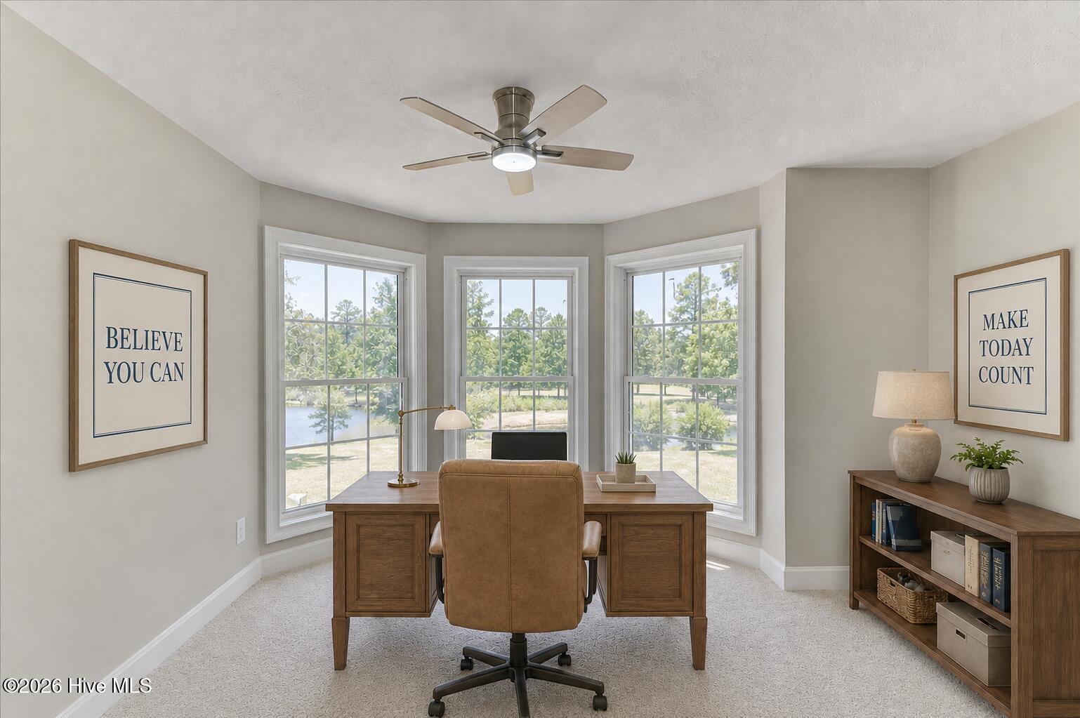 Virtually staged as a home office. Furniture and décor are digitally added and are not included with the property. Facing the Pond. Can you see it?