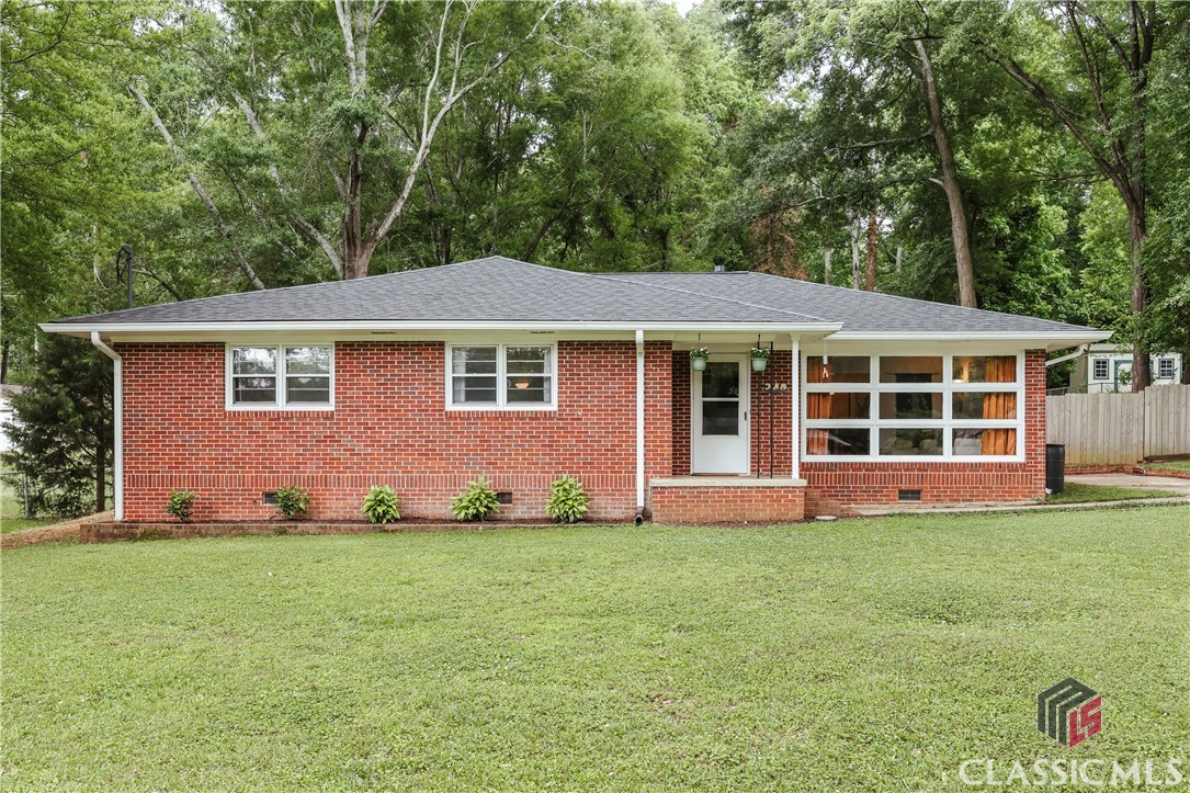Who doesn’t love a 1960’s brick ranch…and at $275k?! Welcome to 240 Janice Drive, a 1532 square foot home on almost half an acre, ideally located on the Westside of Athens between Whitehead Road and Homewood Hills.Built in 1967, the exterior of the house is eye-catching with its prominent wall of mid-century windows. Inside, the interior showcases beautiful hardwood floors throughout most of the house. The large living room is bathed in natural light and flows to the dining room and adjacent kitchen. The kitchen features granite countertops and fun black and white checkered flooring, and includes an exterior door to the deck and backyard. The floorplan unfolds in a similar manner to many ranches, with a central hall leading to 3 bedrooms and a full bath. The full bath also houses the included washer and dryer in a laundry closet. The bedrooms stand out with fun, bold colors and painted real wood paneling.The backyard is sprawling AND fully fenced for any furry friends. A new wood patio is right off the kitchen, and an included shed provides additional storage.Infrastructure upgrades include a 3-year old roof with gutters, new water supply line from the meter and new sewer line to the street. The HVAC was serviced in April 2024. The crawlspace has been improved with a new vapor barrier, and there is a current termite bond on the house.Convenience is key with the new Publix at Oak Grove less than 2 miles away, Normaltown restaurants and Bishop Park 2 miles away, and the University of Georgia just 4 miles away. Come take a look at this brick charmer today!