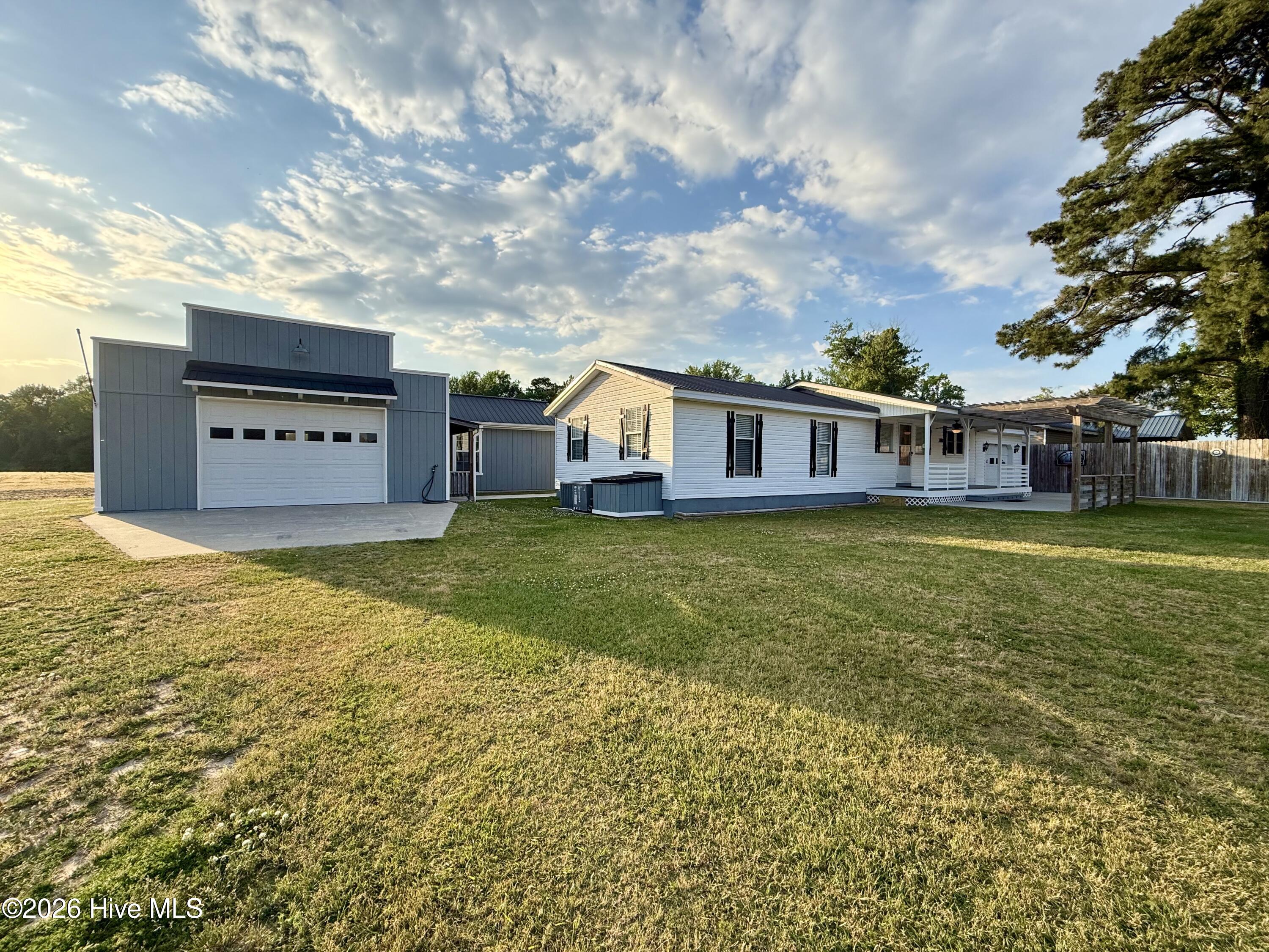 Just listed outside the Town of Bear Grass, NC! Enjoy the peace of a rural setting with no restrictions while still having a home that feels fresh, comfortable, and move-in ready. This charming 2-bedroom, 2-bath home offers an updated interior with a bright and welcoming layout designed for everyday living.Step inside to find new LVT flooring flowing through the living room, dining area, and kitchen, creating a clean and modern feel throughout the main spaces. The kitchen features updated appliances, an eat-at bar top for casual meals, and easy access to the formal dining area just off the kitchen.The guest bedroom offers new carpet and a walk-in closet, while the nearby guest bathroom includes a full tub/shower combination. The primary bedroom is filled with natural sunlight and features its own private en-suite bathroom with a full tub/shower combo. A convenient laundry closet is located near the primary bedroom hallway and includes a washer and electric dryer.Outside, the attached garage provides excellent bonus space for storage, hobbies, or projects, while the detached garage offers even more room for tools, equipment, or recreational use. With its rural setting, updated interior, and flexible garage spaces, this Bear Grass area property is full of opportunity. Schedule your private showing today before it is gone!