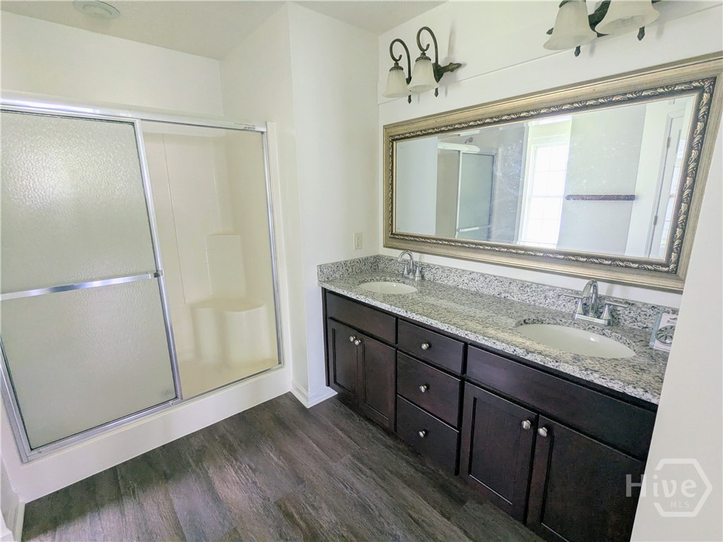 Master bath vanity with new granite top and large shower.