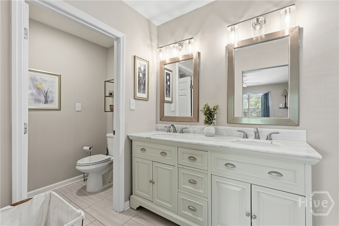 Primary bathroom 1 with dual vanity sinks and separate water closet