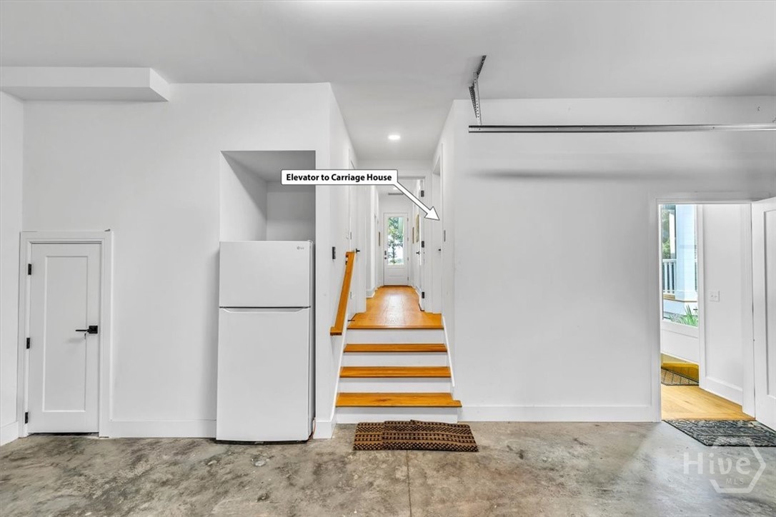 Private entrance to elevator or stairs to carriage house from garage, or from the outside of the garage on the opposite side.