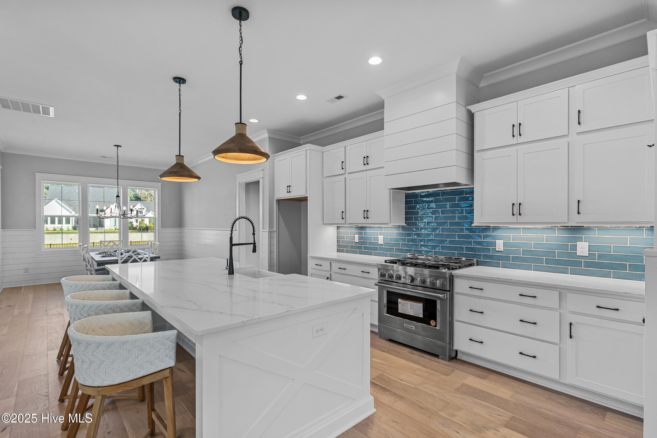 Kitchen with large island, sink, and seating