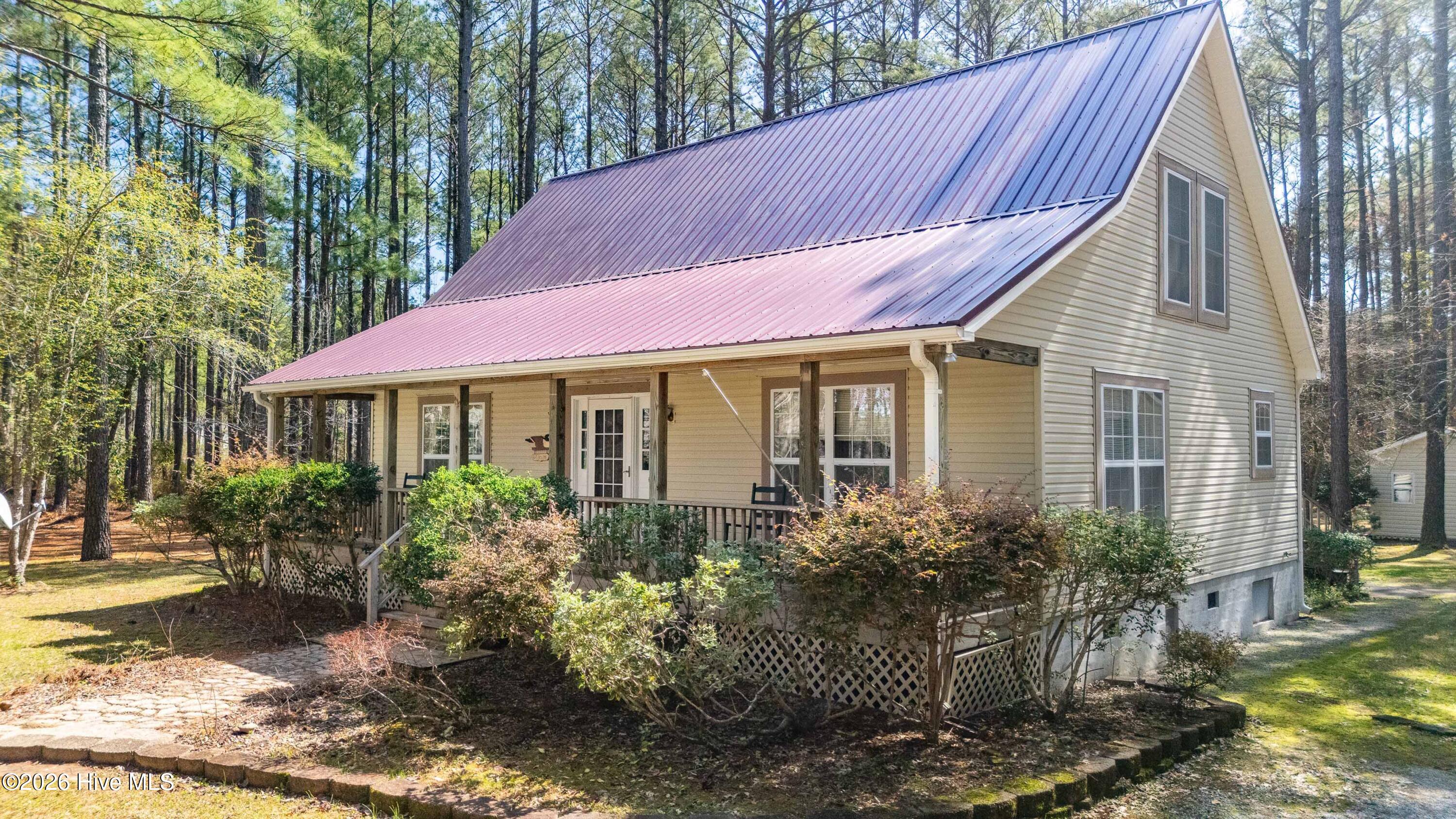A Private Coastal Retreat on 10.77 Acres. Nestled within the peaceful setting of Bay Shores Estates, this remarkable 10.77-acre property offers the rare combination of privacy, comfort, and the relaxed coastal lifestyle that defines life in Pamlico County.A welcoming front porch introduces the home's warm and inviting character. Inside, the thoughtful floor plan blends classic charm with comfortable living. A formal dining room with rich wood flooring provides an elegant space for gatherings, while the spacious living room features a gas log fireplace and opens to a screened porch just off the living room and kitchen--an ideal place to enjoy quiet mornings or evening breezes overlooking the surrounding landscape. The primary bedroom is conveniently located on the first floor and adjoins an en-suite bath, with direct access to the laundry area and mud room for everyday ease. Upstairs, two additional bedrooms and a full bath offer comfortable accommodations for family and guests. The kitchen is equipped with stainless appliances, including a Samsung refrigerator, GE dishwasher, and GE range, complemented by solid surface countertops designed for both durability and style. A detached double garage provides excellent space for vehicles, storage, or hobbies and includes two gas heaters, air conditioning, and a hot water heater. The finished upper level features a full bath, sink, and microwave, offering flexible space for a variety of uses. Additional highlights include a metal roof installed approximately two years ago, tile flooring in the den, and carpeted bedrooms. Owners in Bay Shores Estates also have access to a deeded boat slip through the neighborhood boat owners association. While the slips currently require rebuilding, the association offers the opportunity for future boating access to the beautiful waters of Pamlico Sound. With expansive acreage, inviting living spaces, and boating potential, this special property offers a rare opportunity to enjoy the natural beauty and tranquility of Merritt, North Carolina.