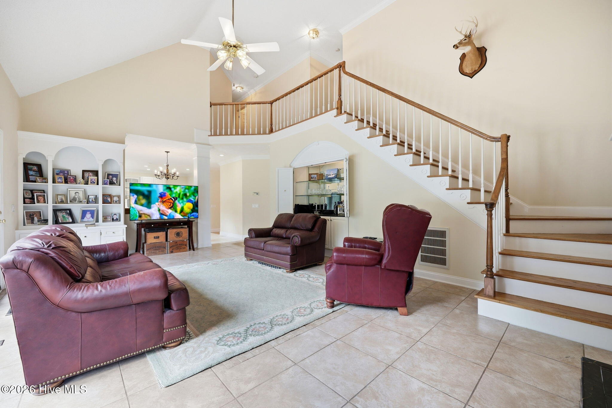 the back living overlooks the pool and steps off to a raised patio
