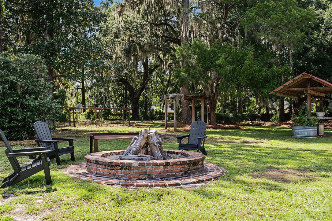 Oyster pit, oyster shucking station, garden with raised beds, and chicken coop