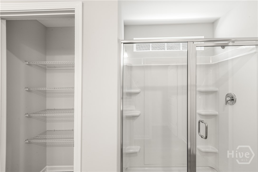 Primary Bathroom Shower and Linen Closet
