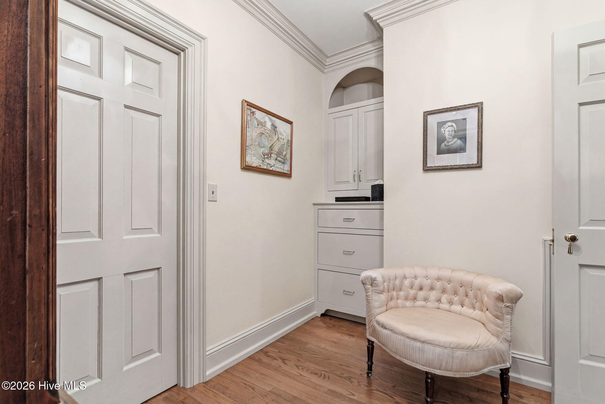Primary suite 2nd dressing room with walk-in closet and built-in cabinetry.