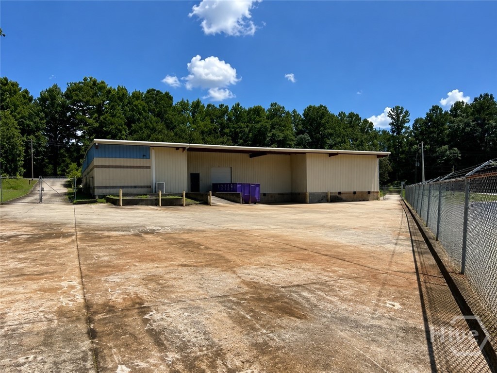 Rear yard with chain-link fencing and barbed wire