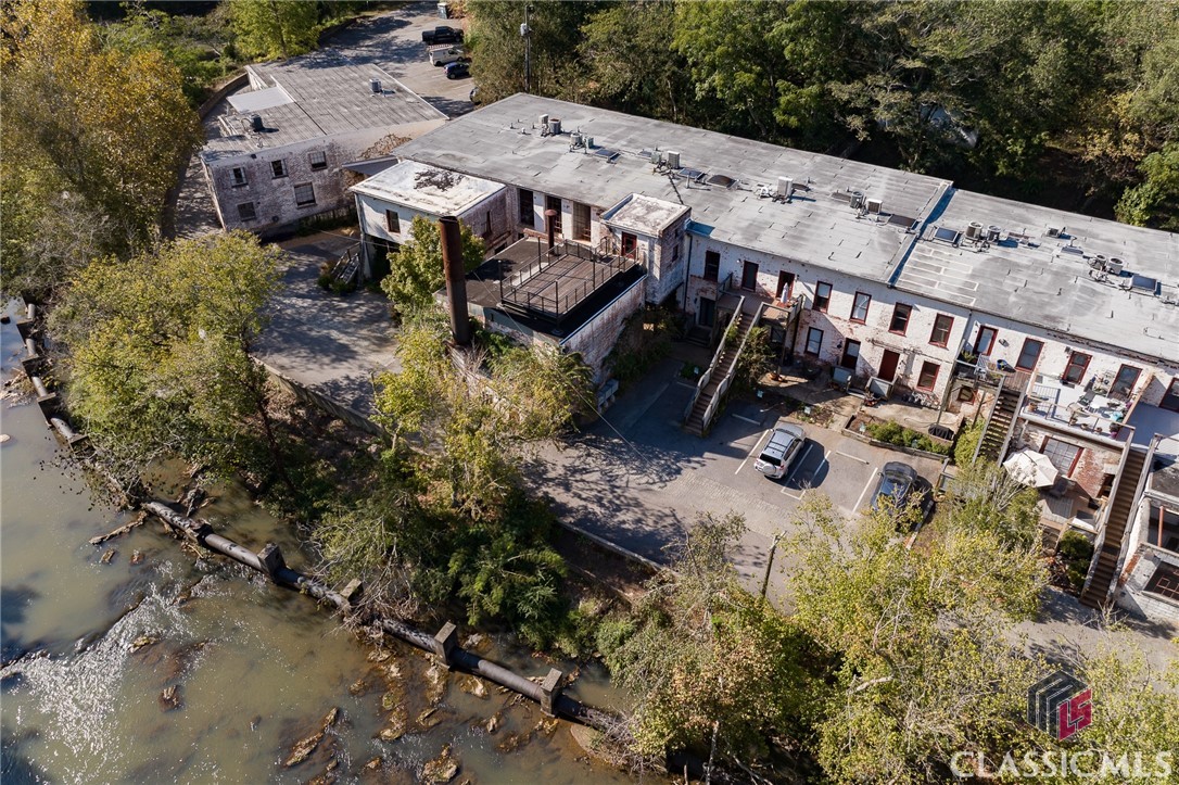 Beautifully Updated Whitehall Mill Loft on the north Oconee River. Enjoy the peaceful setting form the large deck. Sellers made lots of improvements beyond just the cosmetic. Exposed brick interior walls, properly sealed, new tankless water heater and HVAC among others. Perfect indoor/outdoor living. Multi-Level floor-plan with living area and kitchen on 2nd floor at the entrance. Bedroom & bathroom downstairs, along with an additional seating area . Secluded, quiet and exceedingly charming property.