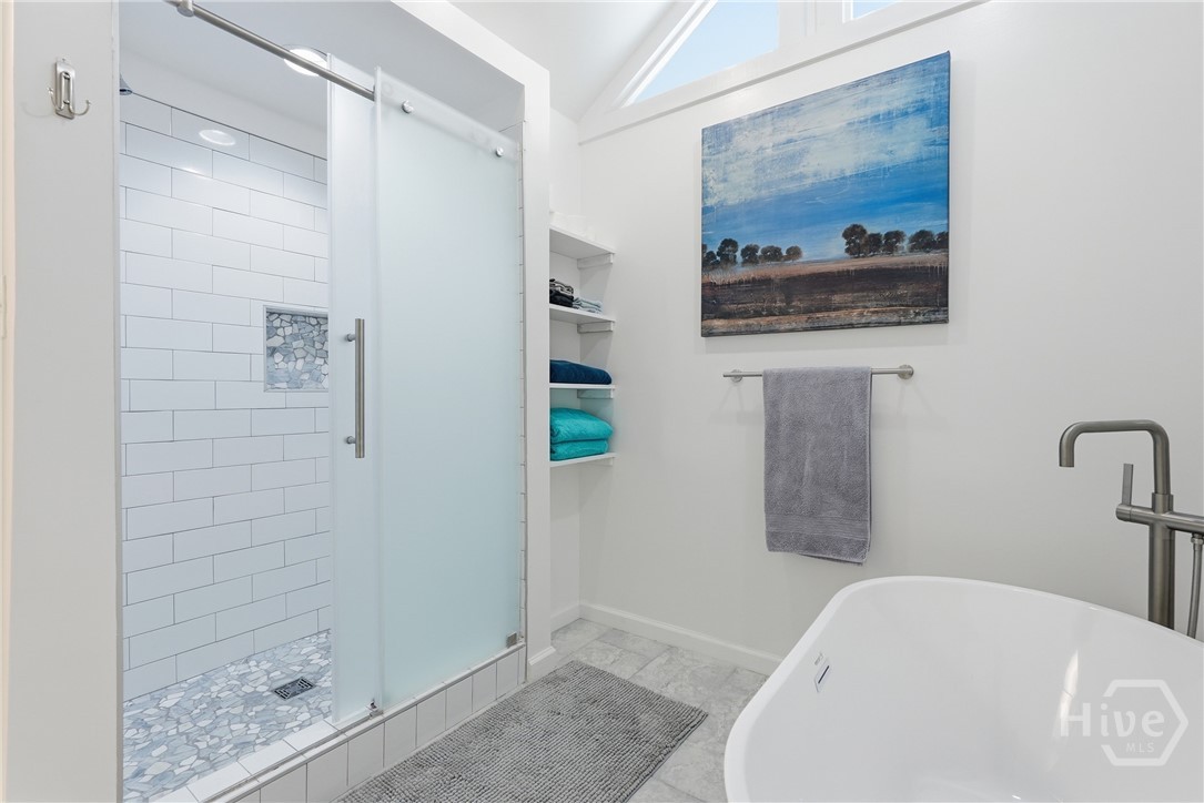 Primary Bathroom is bright and features a separate