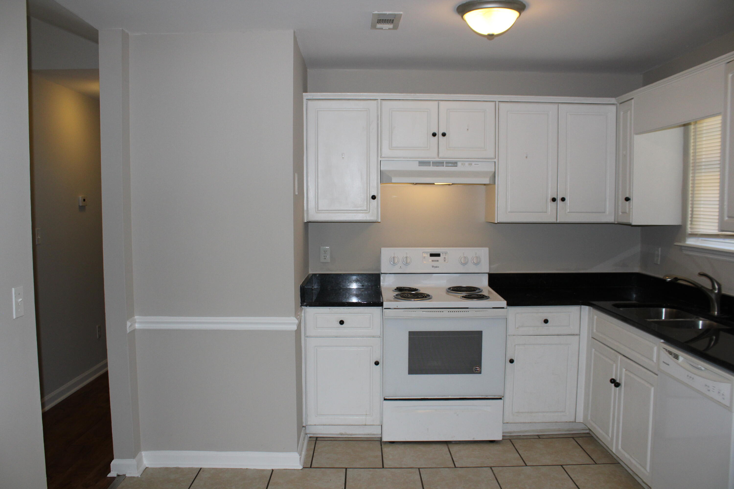 Electric range, dishwasher and refrigerator included.