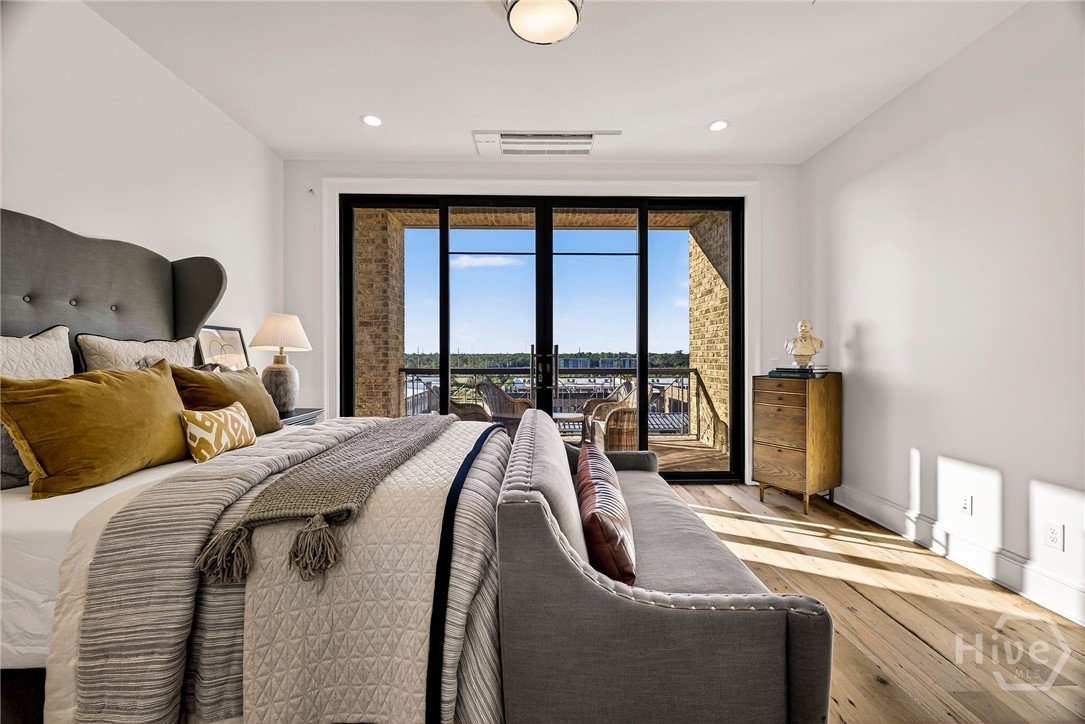 Bedroom 3 - This light-filled bedroom is anchored by expansive glass doors that open to a private outdoor space. The layout supports flexible furniture placement and includes a dedicated media wall, ideal for personalized living. A serene setting with elevated privacy and natural ambiance.