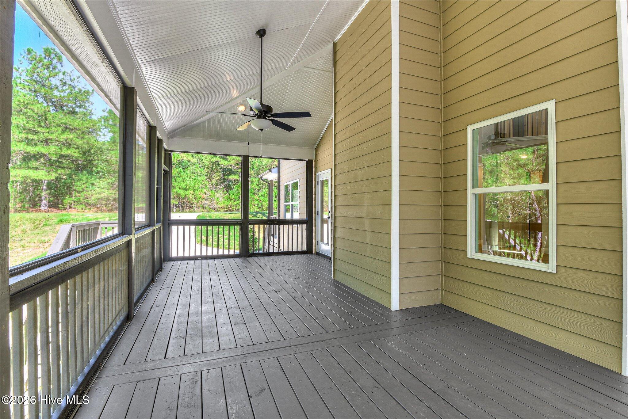 Rear screened porch stretches down the right side and across the back of the home.