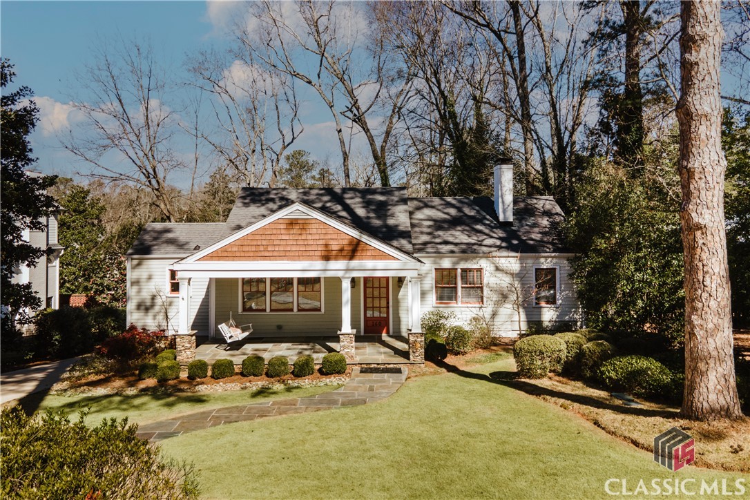 This is the street you have always dreamed of living on, but never thought you'd have the opportunity to do so. This sought after cul de sac street is in walking distance to Five Points and UGA sport facilities, not to mention Barrow Elementary.  One of the greatest features of this home is the spacious covered rocking chair front porch overlooking a well maintained yard and charming stone sidewalk.  The curb appeal will immediately catch your attention!  Offering three bedrooms and three full baths on one level, this home is super functional with multiple living spaces. Hardwood floors span the main home, and both the sunroom and home office have a neutral carpet. Upon entering the home, you have a small foyer that opens into a sizable great room with a gas fireplace. From this  room, you have access to the large formal dining room, a french door leading to the sunroom and home office, and access to the hallway towards a guest bedroom and full hall bath.  The kitchen has ample cabinetry, black granite countertops , a deep walk in pantry,  large island and great views overlooking the rear deck. A keeping room connects the kitchen to the newer rear addition which is home to a secondary bedroom, full bath, primary suite and an open stairwell to the terrace level rec room. The two rear bedrooms both have access to the side screen porch which was built with trex flooring. The primary bath boasts two separate vanities, a lavatory closet, jetted tub and large walk in shower. The bright and wide open stairwell leading to the rec room offers great natural light to the rear of the home. The terrace level rec room has a pool table that will convey with the property and has two doors that open into the two car garage, and a French door leading to the exterior. The opportunities are endless with this Five Points cottage!