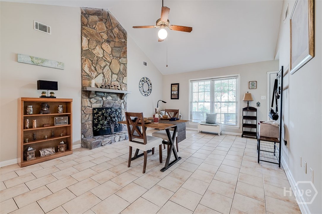 You are welcomed by the cathedral ceiling in the dining/family room with a stone, wood burning fireplace taking centerpiece and reachin the top of the ceiling.