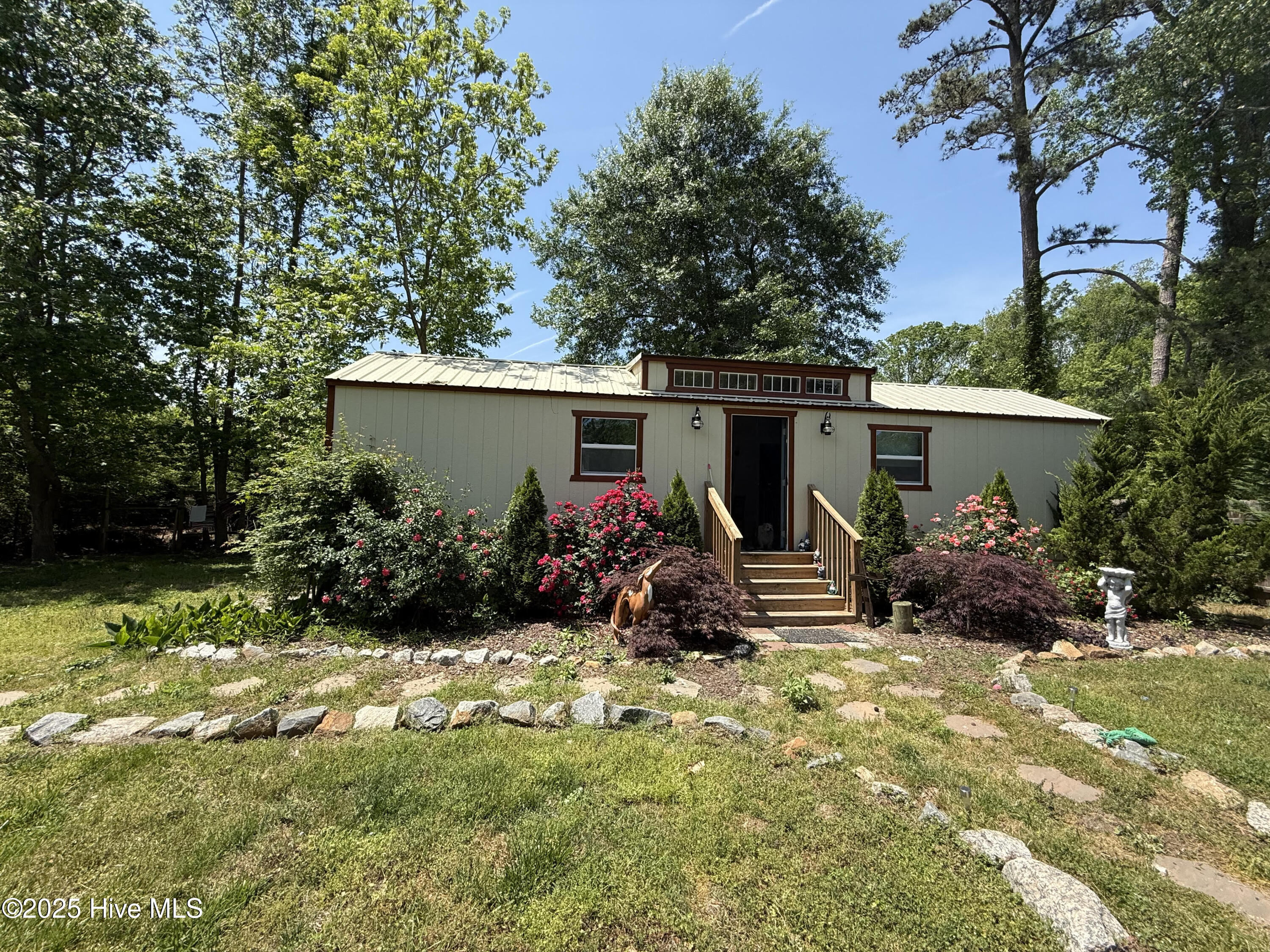 Are you looking for a restoration home, but need someplace to live in the process.  This beautiful landscaped property has a cottage that is +/-1020 sf with 2 bedrooms, bathroom and an open concept living area with kitchen and family room.  The unique cottage was built using 2 storage buildings ,one being the living and kitchen areas.  The connecting room holds the bathroom and the laundry area.  Then the portion on the back is another large unit containing the two bedrooms. All appliances are included in the sale.
The restorable house (I actually went inside) has 4 large rooms downstairs and 2 larger rooms on the second floor. The tax data says 1572 sf.  Some electric upgrades have been made to the house.
The yard is completely fenced in with so many flowers, Japanese Red Maples, rose bushes and a Coy Pond with waterfalls.  To enjoy that setting more is a cozy firepit on the stone patio.  Yes it's a project but has much potential.  It is a must see if you are up for the project.