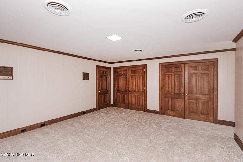 Bedroom 3 with carpet over hardwood and bookshelves and desk