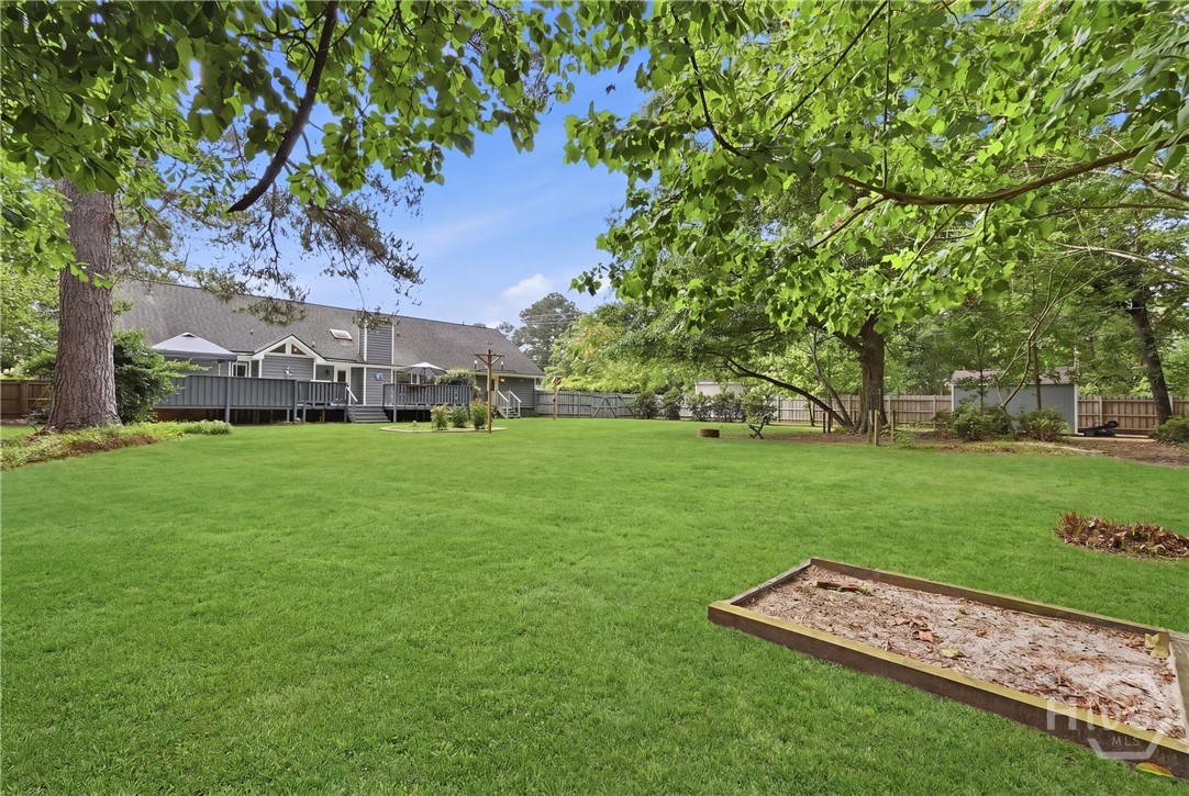 The property features a privacy fence and mature t