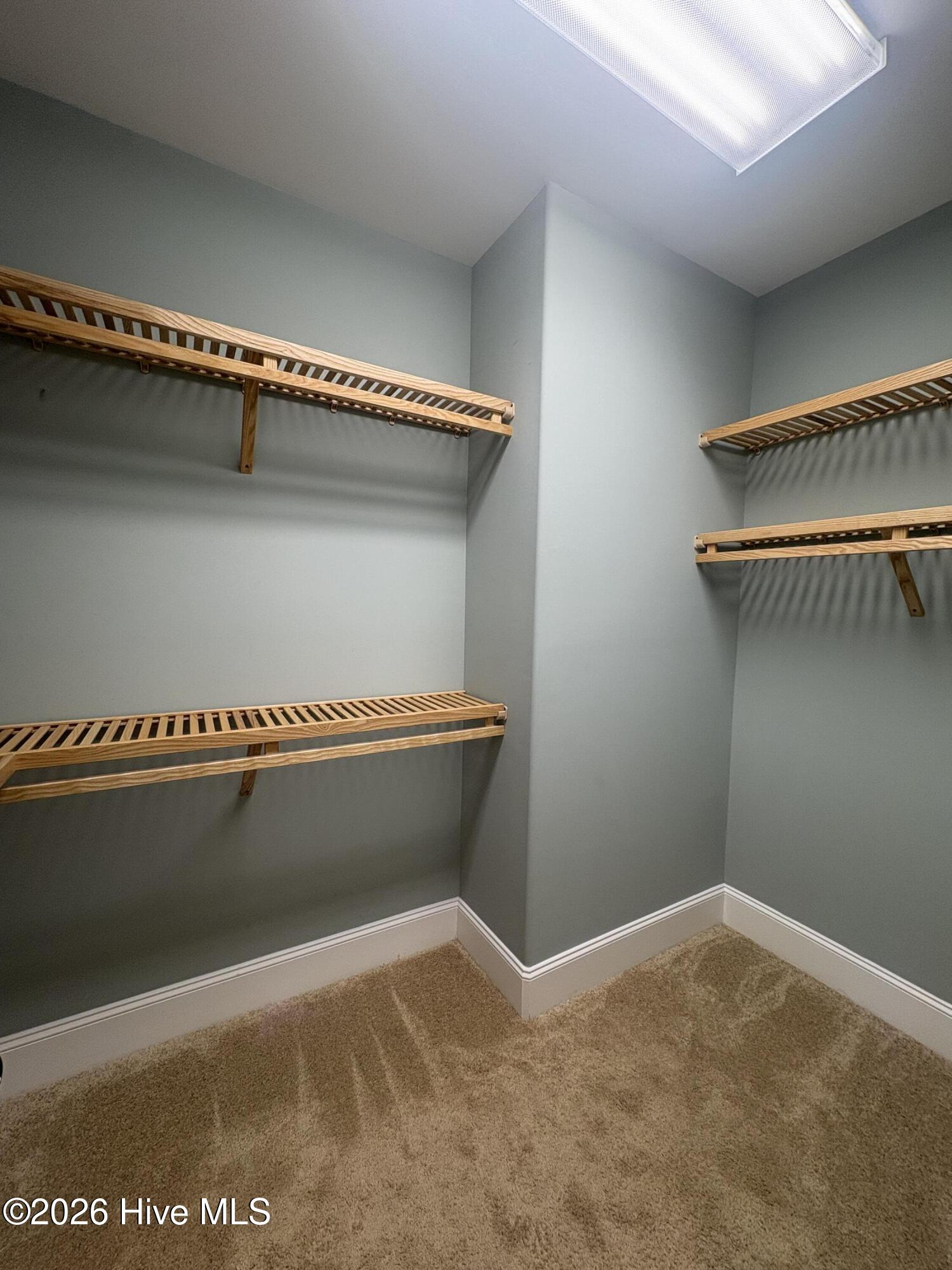 walk in closet #2 with built in wooden shelves