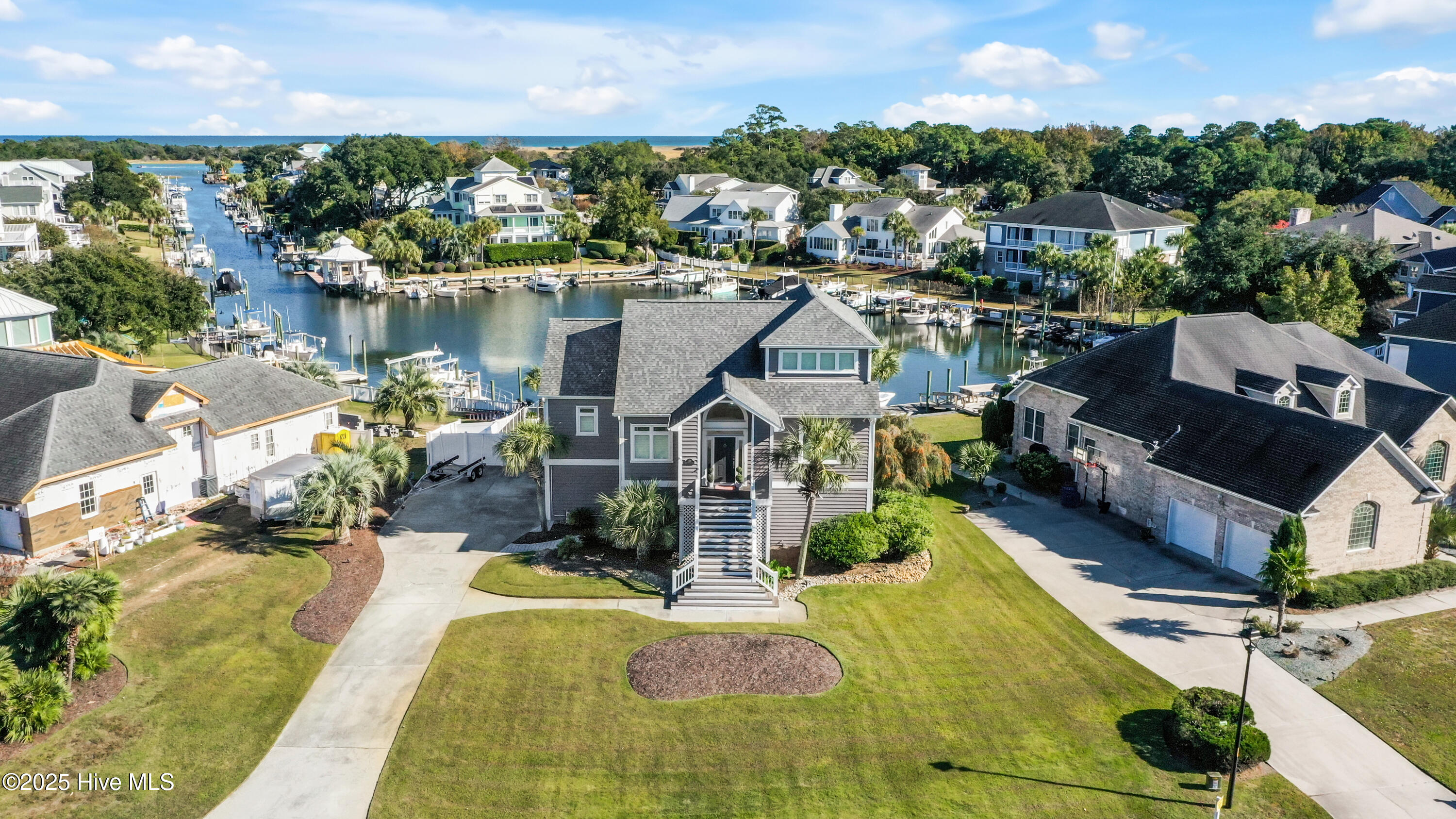 Incredible opportunity to own a waterfront home in the desirable Inlet Point Harbor community. Enjoy beautiful views and direct access to the Intracoastal Waterway from your private dock with drive-on boat slip and deep water year-round. This home features an open floor plan with 4 bedrooms, 3.5 bathrooms, an office, and a bonus family room. The spacious primary suite is located on the main floor and includes a custom professional closet system. Recent updates include renovated bathrooms, newer carpet and flooring on the second and third floors, updated deck, new Hvac system, and hardware throughout, plus new lighting fixtures and ceiling fans. The property also offers landscape lighting and a saltwater pool designed for entertaining, with room to add a fire pit area or outdoor kitchen. Located just minutes from Freeman's Park, Masonboro Island, and Carolina Beach