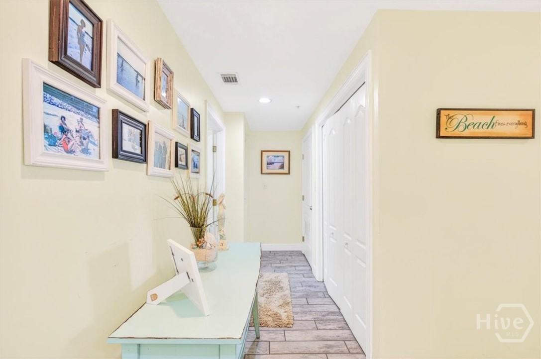 Hallway in the rear of the unit features laundry and stair access to the parking garage below.