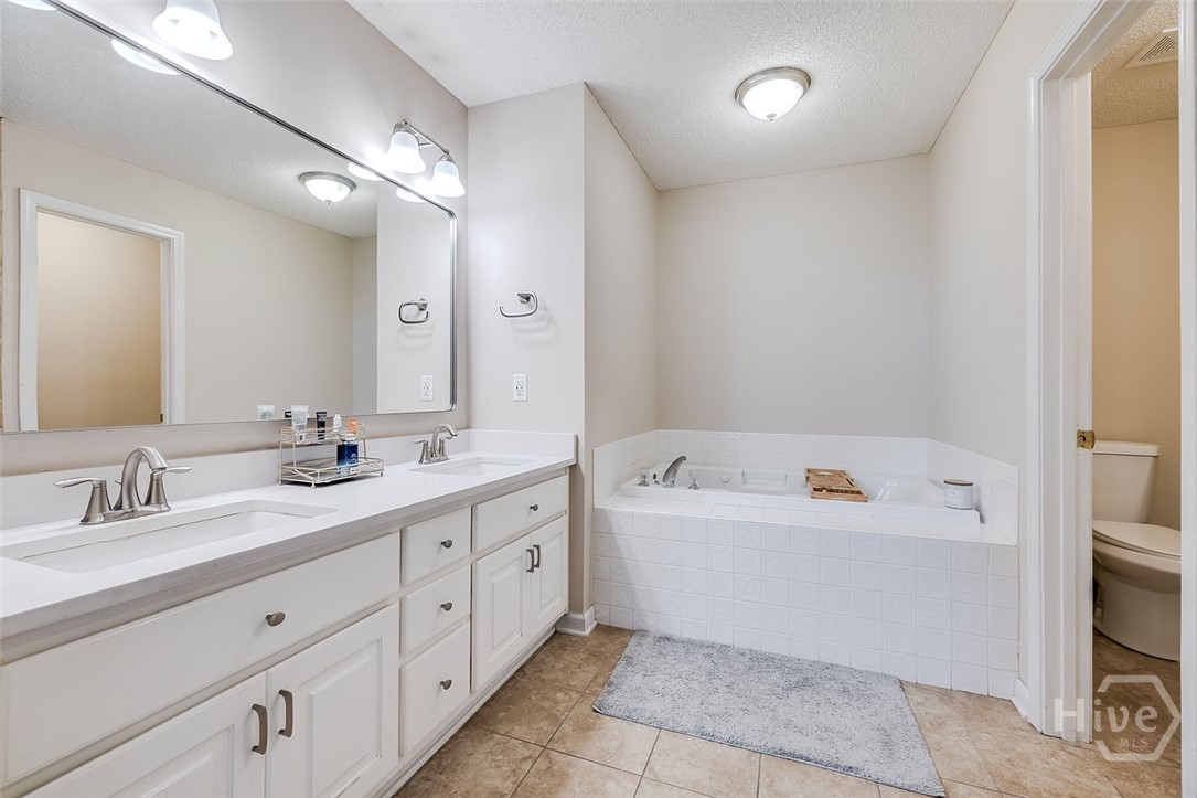 OWNERS BATHROOM WITH WHIRLPOOL TUB AND SEPARATE SHOWER