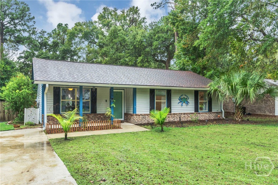 Tucked away in a peaceful setting on Ladys Island, this home sits on a generous lot while still being just minutes from parks, shops, and waterfront amenities. The living room overlooks the front yard, highlighted by custom barn doors across the windows. Distinctive stone and brick flooring through the dining room and kitchen adds a touch of character you won't find in other homes. Out back, the fenced yard is perfect for entertaining or giving your furry and feathered friends room to roam. Four orange trees, a cherry tree, and banana plants line the yard. Additionally, the large shed provides plenty of storage for tools, hobbies, or equipment. Best of all, this property offers the freedom to enjoy the Lowcountry lifestyle without the restrictions of HOAs or covenants.