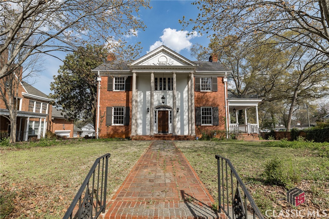 Welcome home to this stately Georgian style 2 level red brick home with an iconic Athens, GA address. Three bedroom two 1/2 bath, approximately 2717 square feet with premier walkable location to restaurants & shopping of Five Points & the University of Georgia campus + neighborhood schools. Fabulous opportunity for a residential home renovation with tons of potential. Two level living with large basement on flat, spacious .37 acres. Lot is 182” deep with 91’ of South Milledge Avenue frontage. Grand front entry. Brick wall on 3 sides in backyard & lovely covered side porch. Member of Selling LLC is a Licensed Realtor in the State of Georgia.