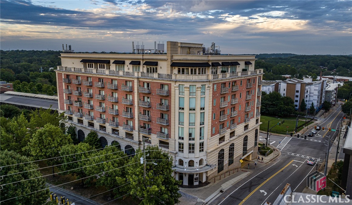Georgia Traditions - Downtown Athens, GA - 3 bedroom Penthouse For Sale. The 1st 3 bed available for sale in Downtown since 2020. Stunning, sweeping views of Athens up Broad Street. 3 numbered, reserved parking spaces in covered on-site deck, key card access to the building. One of the few opportunities remaining for views of Sanford Stadium from the huge outdoor patio. The premium corner suite Penthouse / 9th level is the most spacious Downtown living. 3 bedrooms 2 baths with full kitchen and bathroom renovation. Kitchen has quartz countertops, white cabinetry, dark gray island & stainless steel professional appliances (Sub-Zero & Wolf). Sophisticated living with crown moldings, recessed lighting & gas fireplace in the gracious living area, with floor to ceiling windows. Skyline views from living area, kitchen, primary bedroom, and 2nd bedroom. New electric Traeger grill, all furniture, appliances, linens & housewares included. Personal items & art work not included. Private rooftop swimming spas (one hot, one cold - open year round) with massive sundeck & spacious well-appointed Club Room. Walk to Sanford Stadium & the shopping & dining of Downtown Athens, GA. Occupancy available post November 30th, 2023.