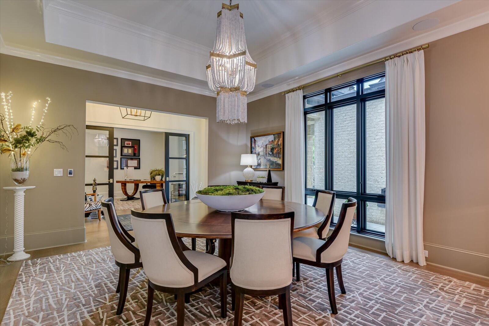Dining Room- High gloss trey ceiling. Floor to ceiling window overlooking the court yard and fountain.