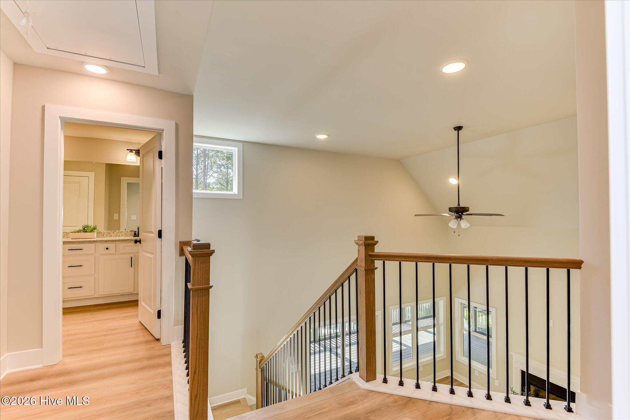Two additional guest bedrooms, a full bathroom, and a utility room are upstairs.
